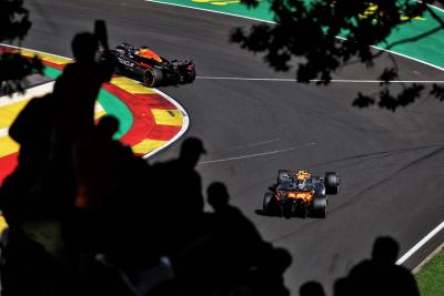 Max Verstappen (NLD) Red Bull Racing RB20 leads Lando Norris (GBR) McLaren MCL38. Formula 1 World Championship, Rd 14,